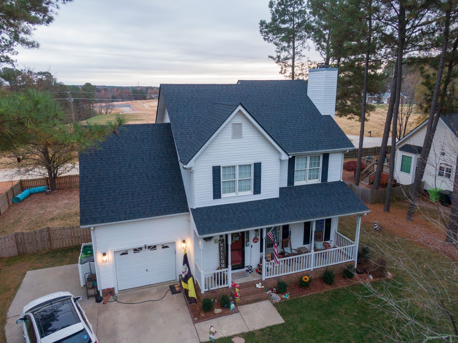 Aerial view of a 2-story Southern home with new charcoal architectural shingle roof